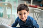 Little boy sitting on the chair.