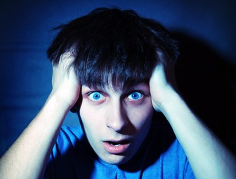 Scared or Shocked Boy Face on Blue Background