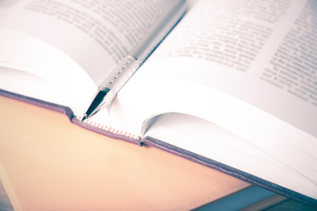 An open legal book with a pen.