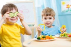 Kids eating healthy food in kindergarten or at home.