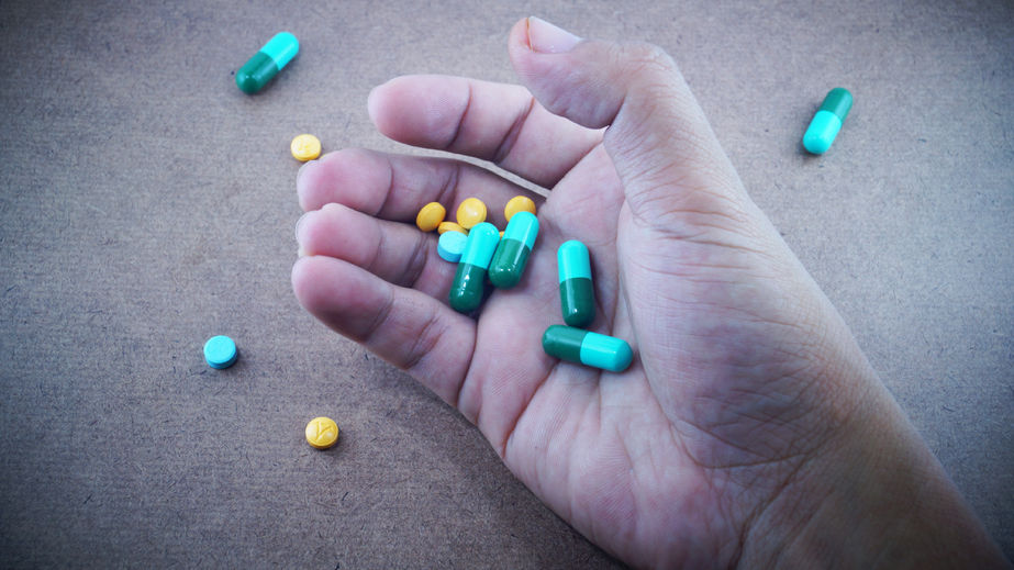 Pills in hand.