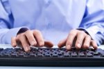 Businessman typing on a computer keyboard.