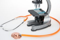 Orange stethoscope and a microscope.