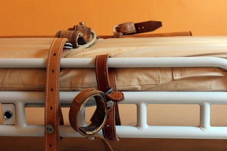 Bed for restraining a patient.